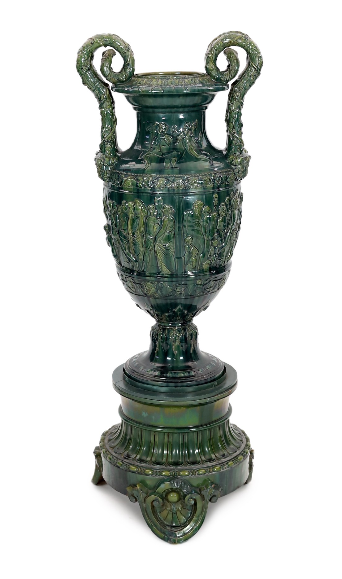 A massive Continental majolica green glazed campana vase and associated stand, late 19th century, total height 153cm, small repairs